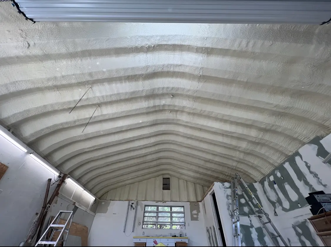 Spray polyurethane foam applied to the underside of a metal roof deck in Worthington